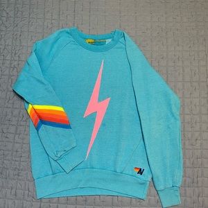Aviator Nation turquoise pullover with pink and rainbow details